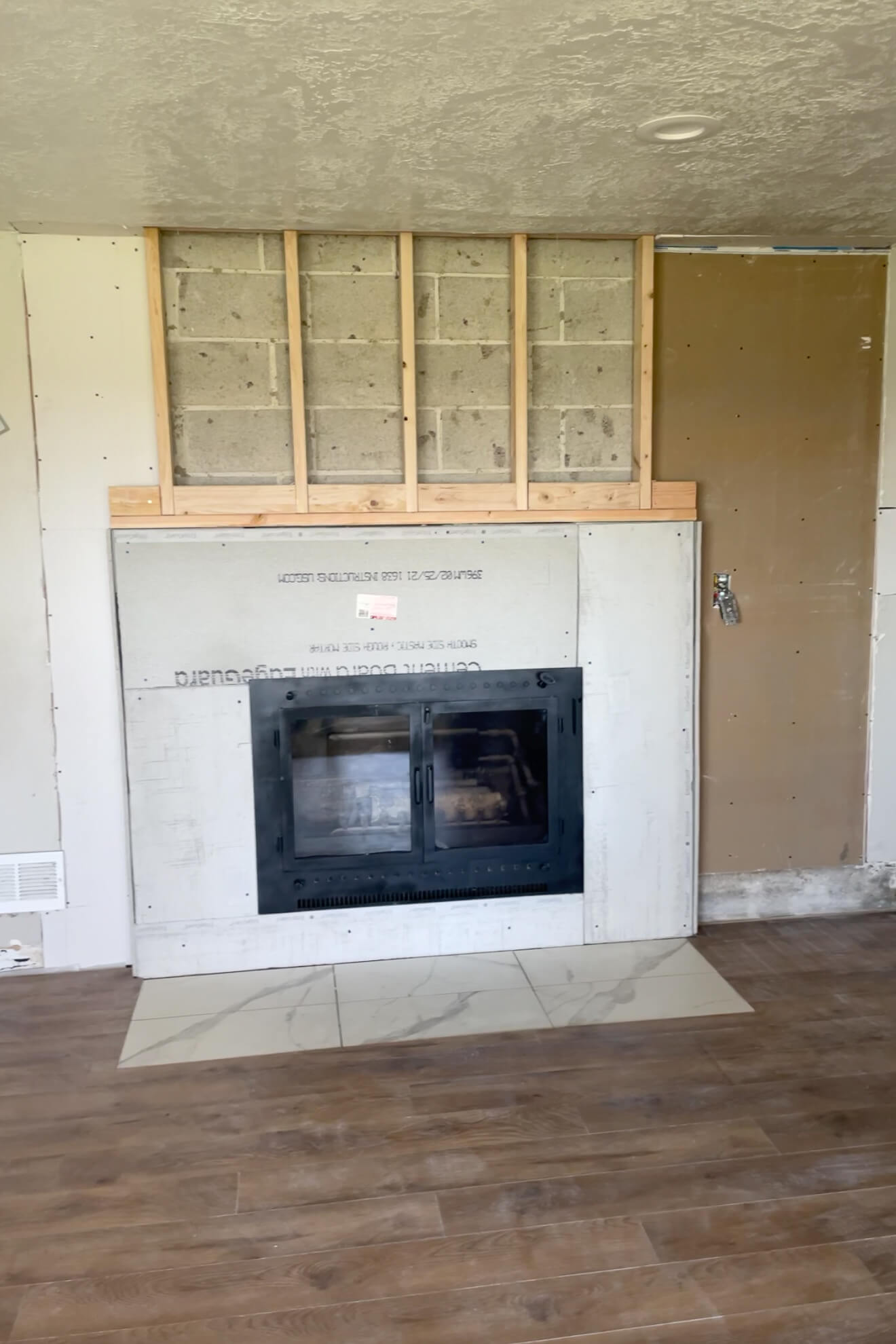 Drywalling around a fireplace.